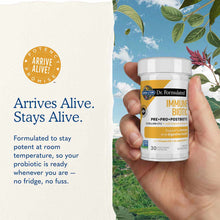 White bottle of Dr. Formulated Immune Biotic supplement held in hand against outdoor background with sky and plants.