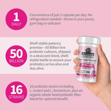 Hand holding a white and pink Garden of Life probiotic supplement bottle against pink background with product feature callout