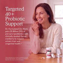 Dr. Formulated Uro Biotic supplement bottle with white label and pink accent displayed on wooden table next to glass of water