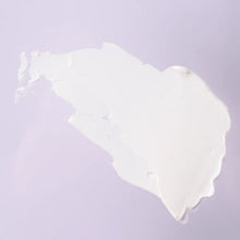 White cream moisturizer swatch on lavender background showing texture and consistency.