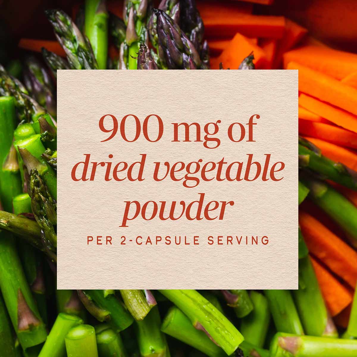 Cream-colored label stating "900 mg of dried vegetable powder per 2-capsule serving" overlaid on fresh green asparagus and or