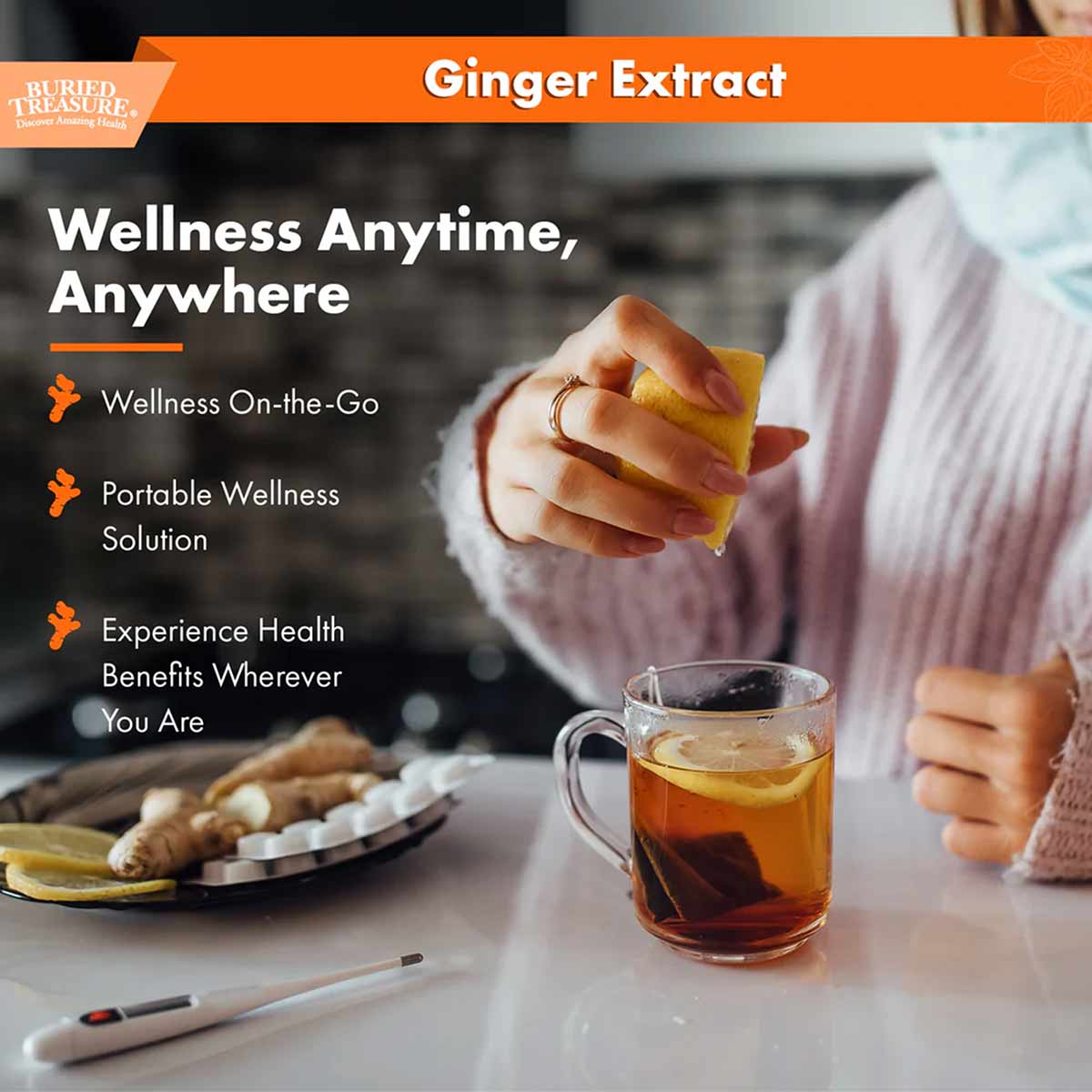 Person in pink sweater holding ginger extract bottle above cup of brown liquid, with fresh ginger root and sliced ginger on p