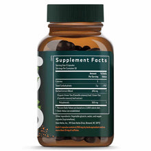 Amber glass bottle with green cap containing dark capsules, label showing Supplement Facts for Green Tea extract by Gaia Herb