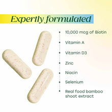 Three cream-colored capsules with red speckles next to ingredient list including biotin, vitamins, minerals, and bamboo extra