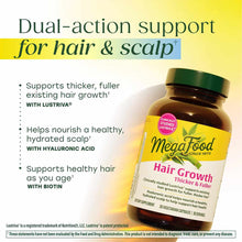 Megafood Hair Growth supplement bottle with green cap on yellow background displaying product claims and ingredient benefits.