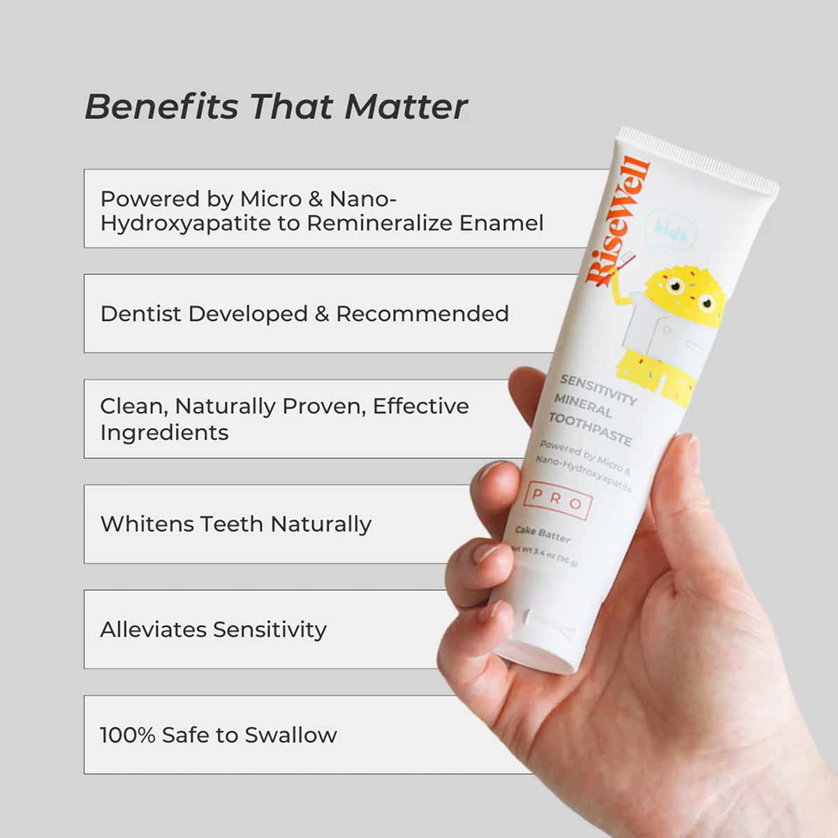 White toothpaste tube with yellow smiley face design held in hand, labeled RiseWell PRO Kids Mineral Toothpaste.