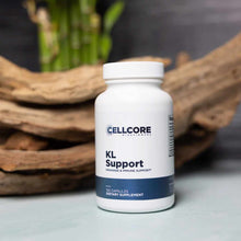 White bottle labeled KL Support by CellCore containing 120 capsules, displayed with wood and green plant styling.