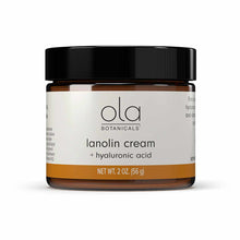 Amber glass jar with black lid containing lanolin cream plus hyaluronic acid by Ola Botanicals, 2 oz size.