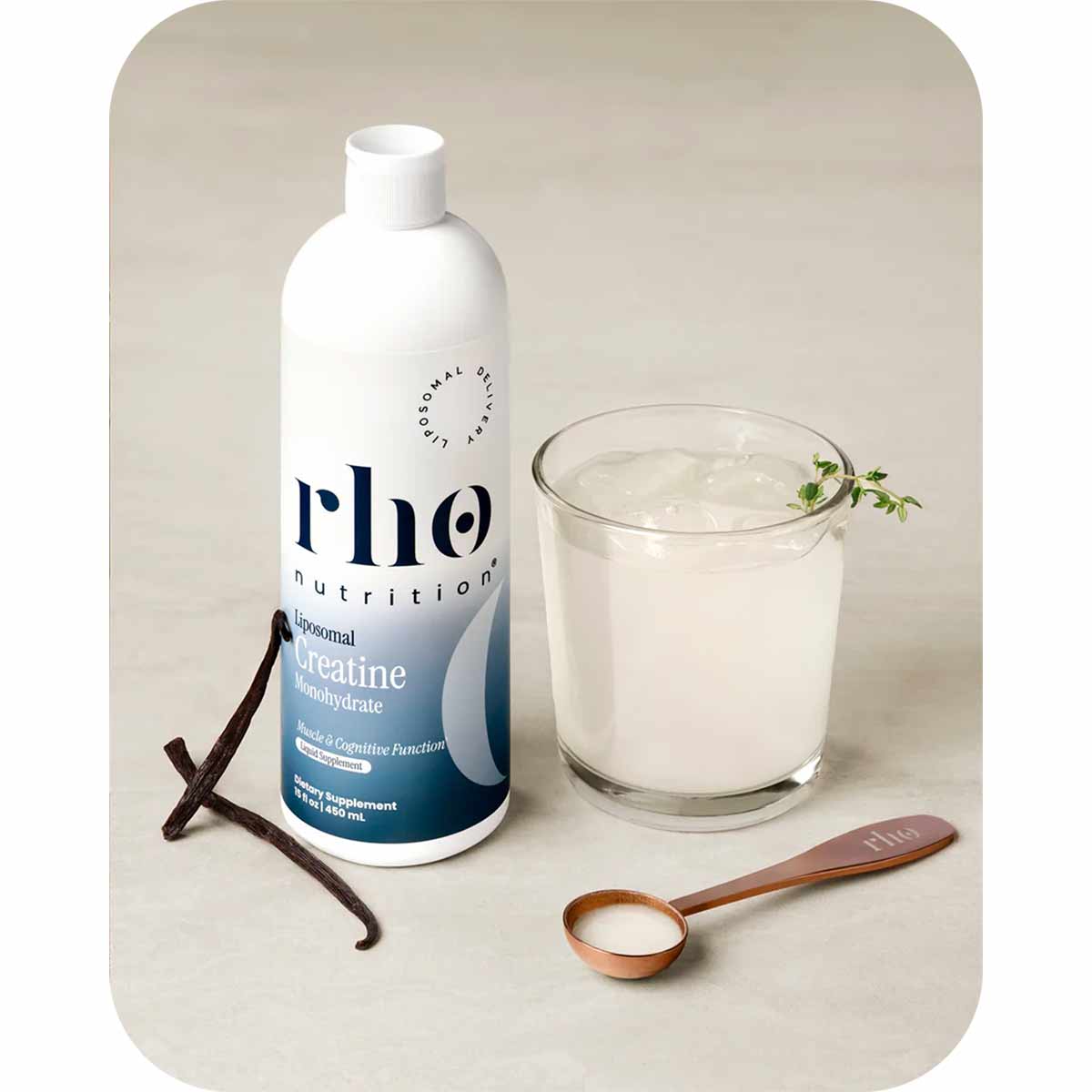 Rho Nutrition liposomal creatine monohydrate bottle with glass of liquid, vanilla beans, measuring spoon, and herb garnish.