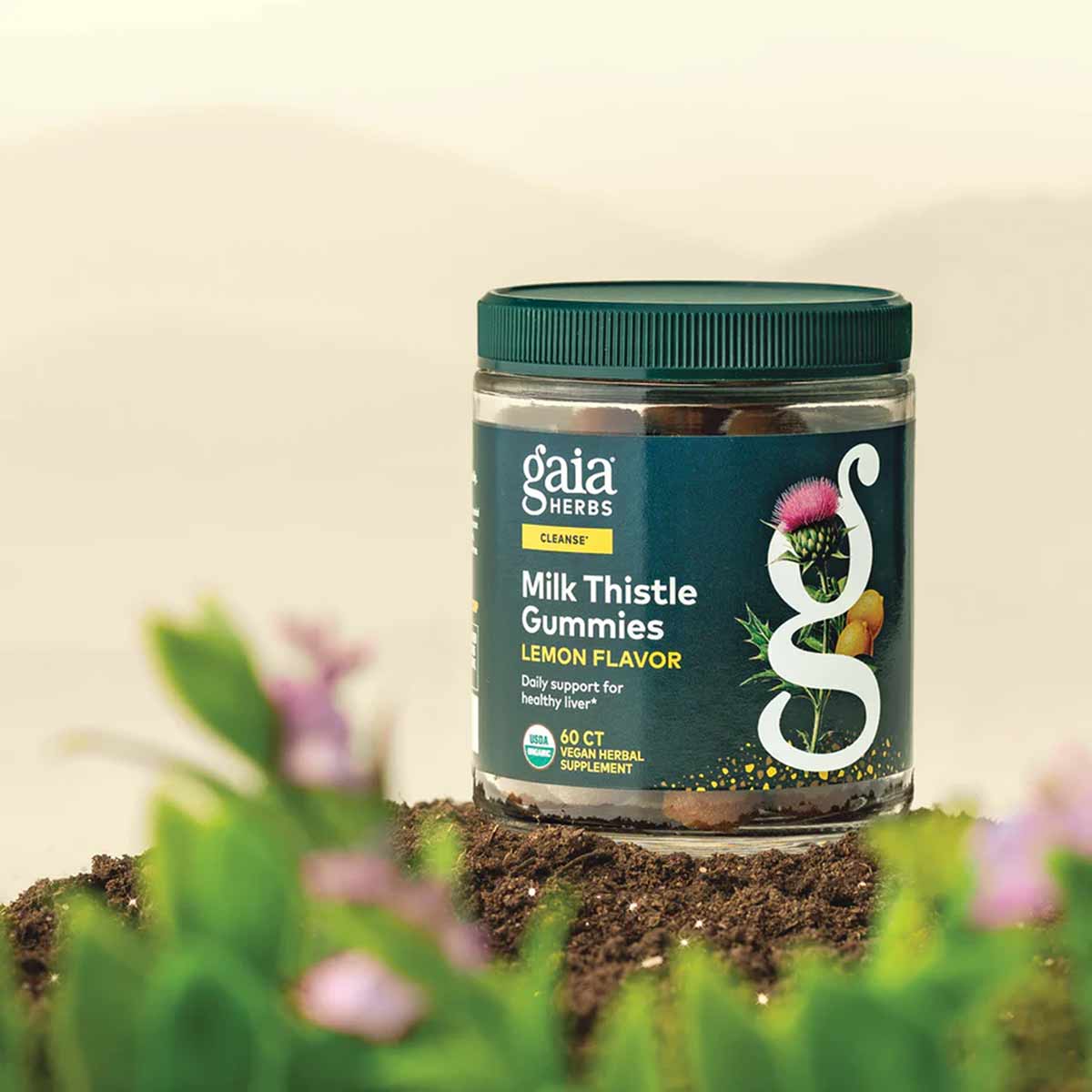 Gaia Herbs Milk Thistle Gummies jar with green cap and dark label, containing 60 count lemon flavored vegan herbal supplement