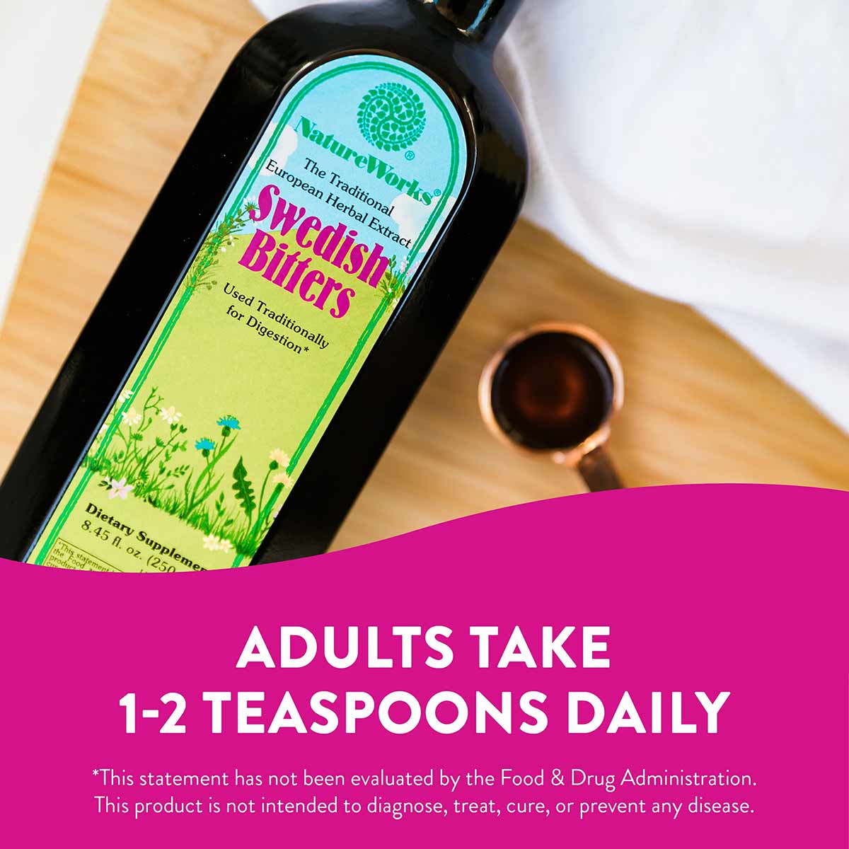 Black glass bottle of NatureWorks Swedish Bitters with yellow-green label on wooden surface.