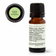 Small amber glass bottle with black cap containing lemon eucalyptus essential oil and green label indicating organic certific