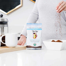 Tyler's Coffee 12oz organic ground coffee package with person pouring grounds into white bowl beside French press and mug.