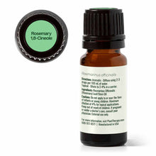 Amber glass bottle of rosemary essential oil with black cap and green label lid showing product name.