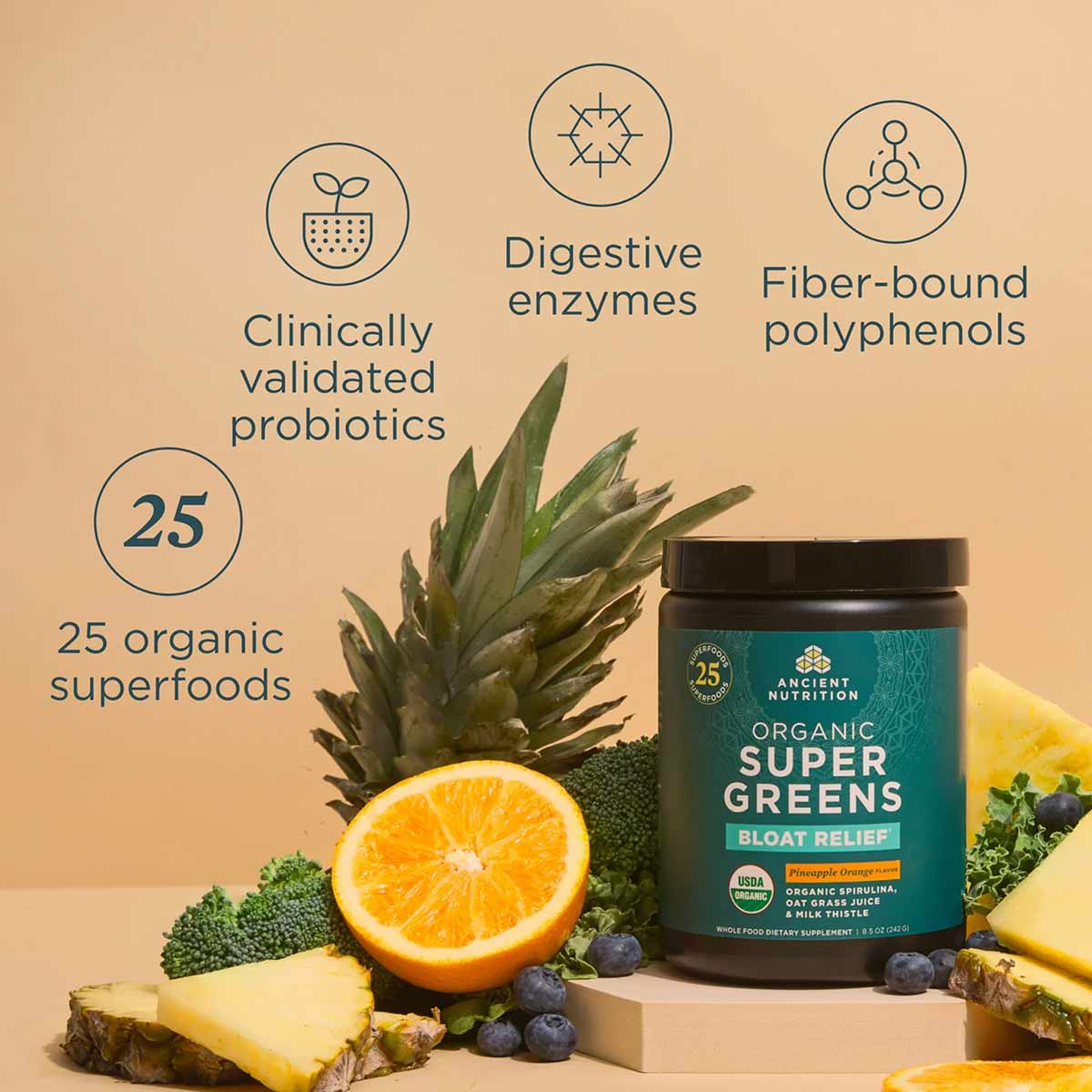 Dark glass jar of Ancient Nutrition Organic SuperGreens + Bloat Relief surrounded by pineapple, orange, blueberries, broccoli