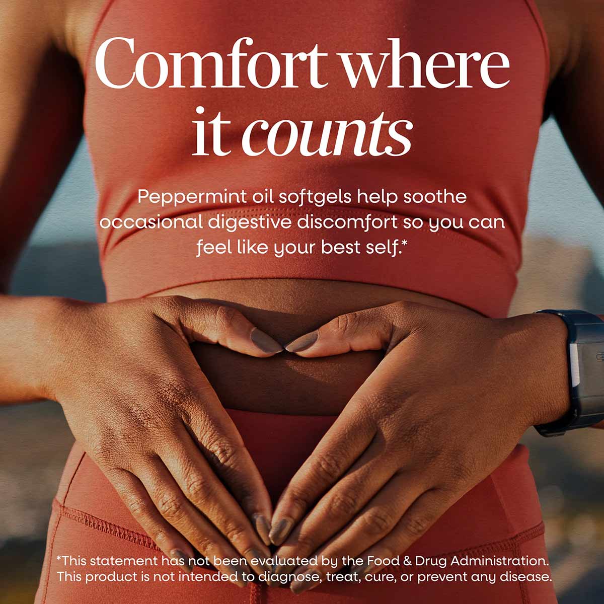 Person wearing red shirt with hands placed on stomach area, displaying peppermint oil product messaging.