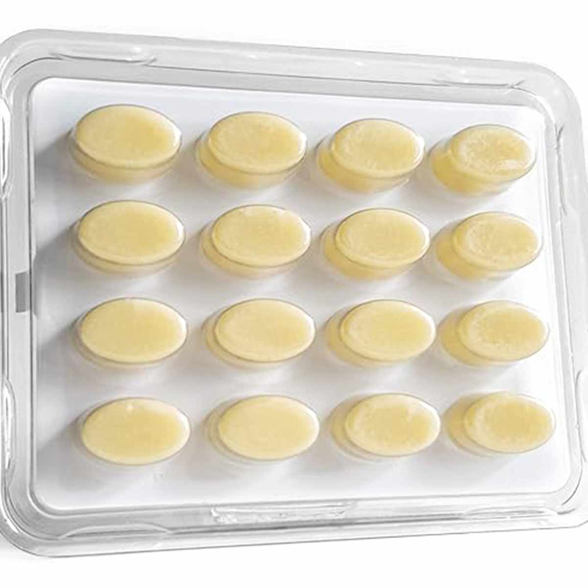 Sixteen pale yellow oval tablets arranged in four rows within a clear plastic blister pack.