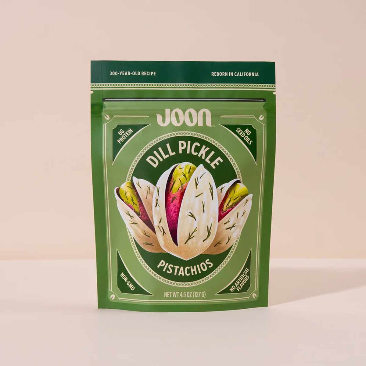 Joon dill pickle pistachios in green pouch with illustrated pistachio shell design, 4.5 oz package.