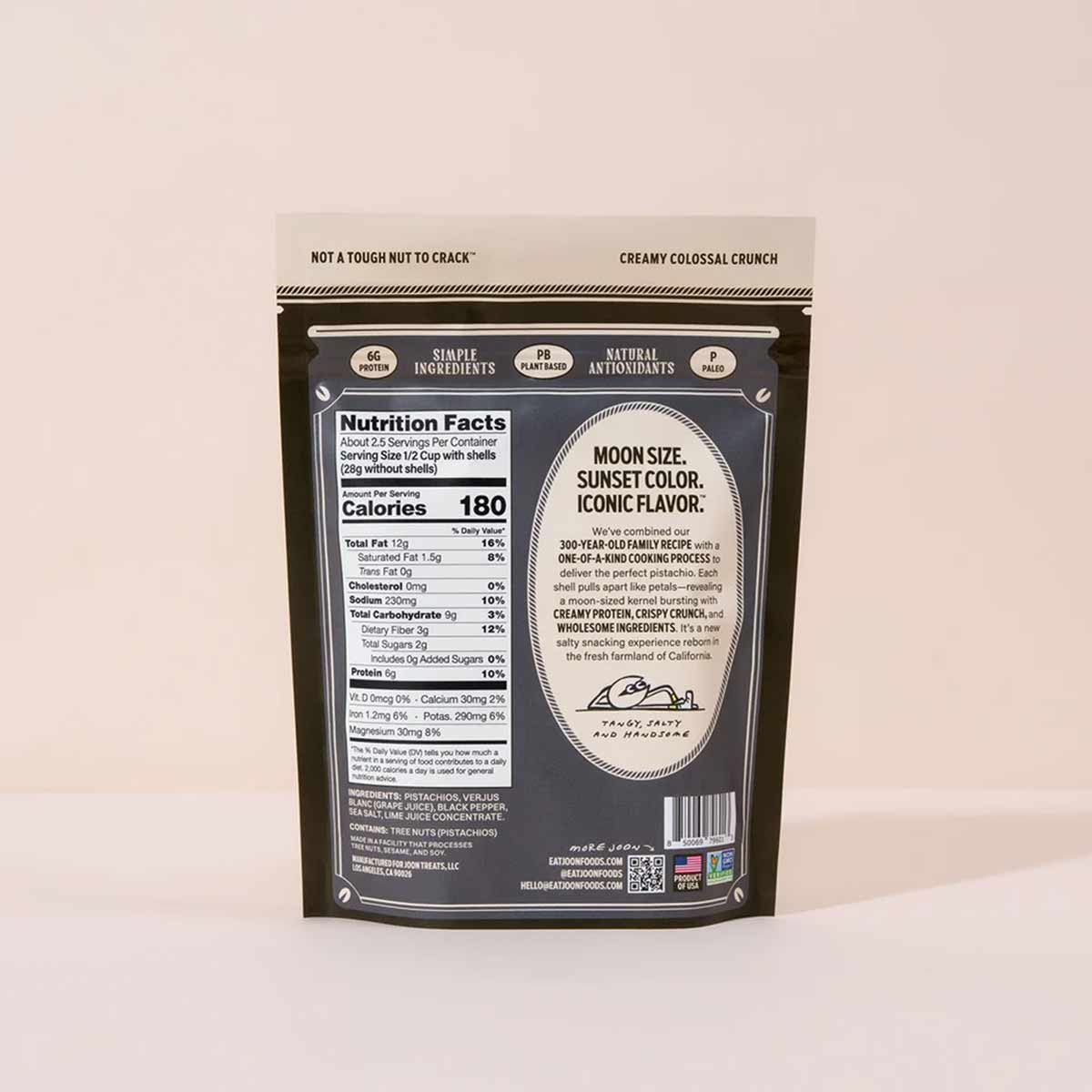 Dark resealable pouch of roasted pistachios with beige and black label displaying nutrition facts and product description.