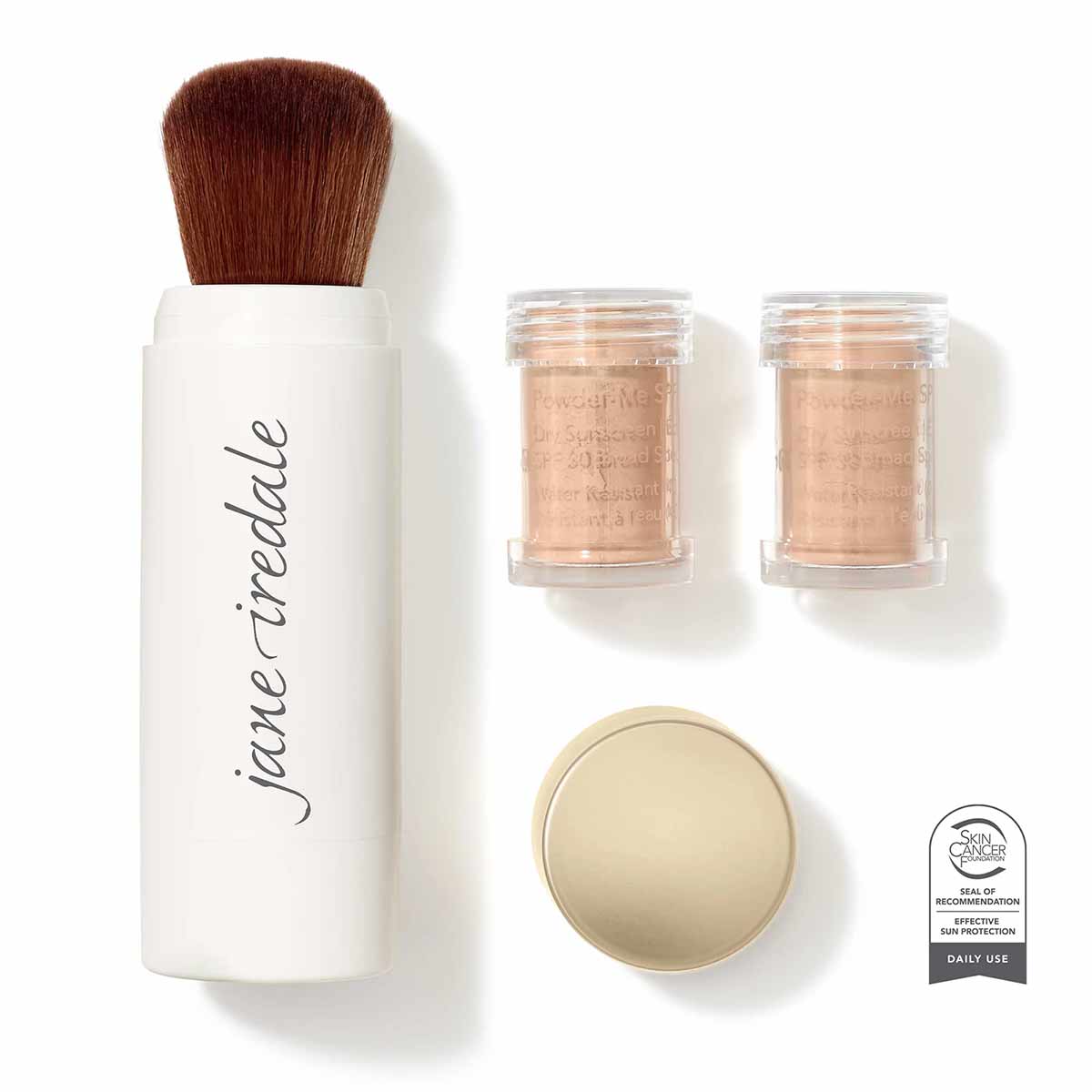 White cylindrical brush applicator with brown bristles, two glass jars of tan powder, one open container of beige powder, and
