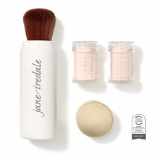 White cylindrical brush container with brown bristles, two clear refill jars, and pale powder compact with skin cancer founda