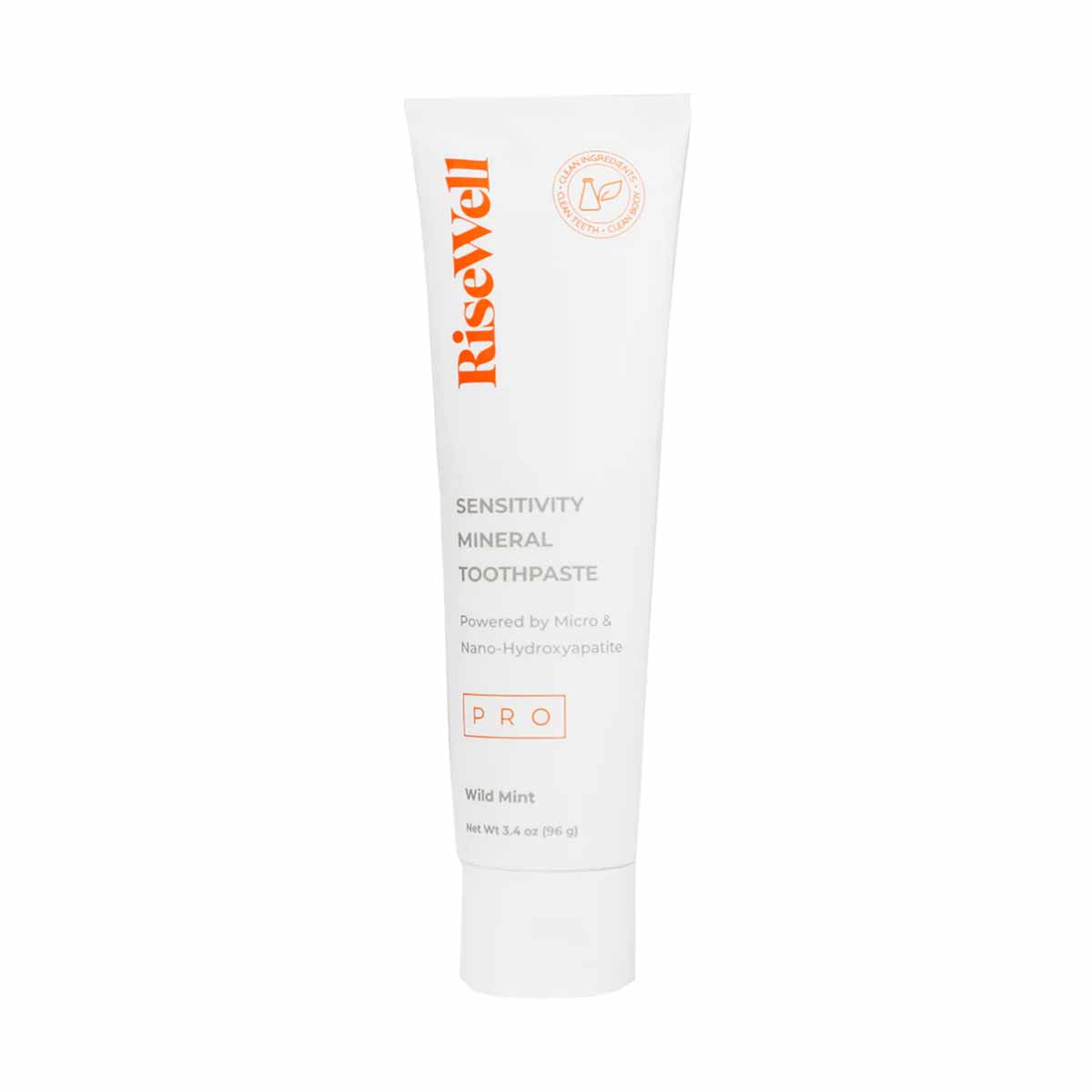 RiseWell PRO Sensitivity Mineral Toothpaste tube in white with orange branding and "Wild Mint" flavor label.