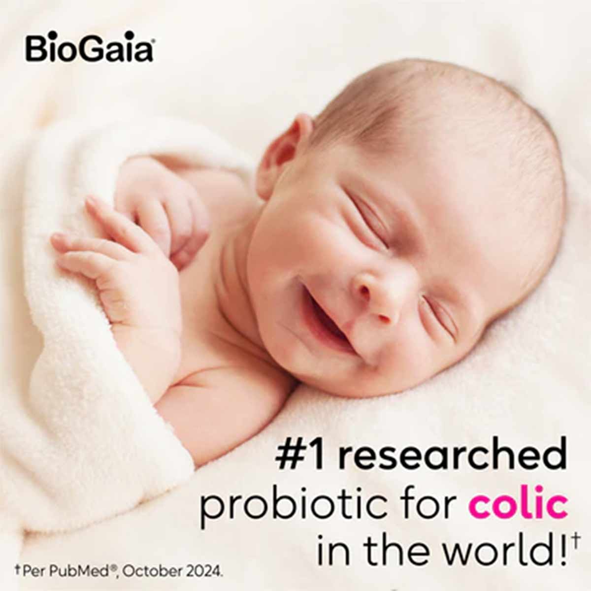 Sleeping newborn baby wrapped in white blanket with BioGaia logo and text about probiotic drops.