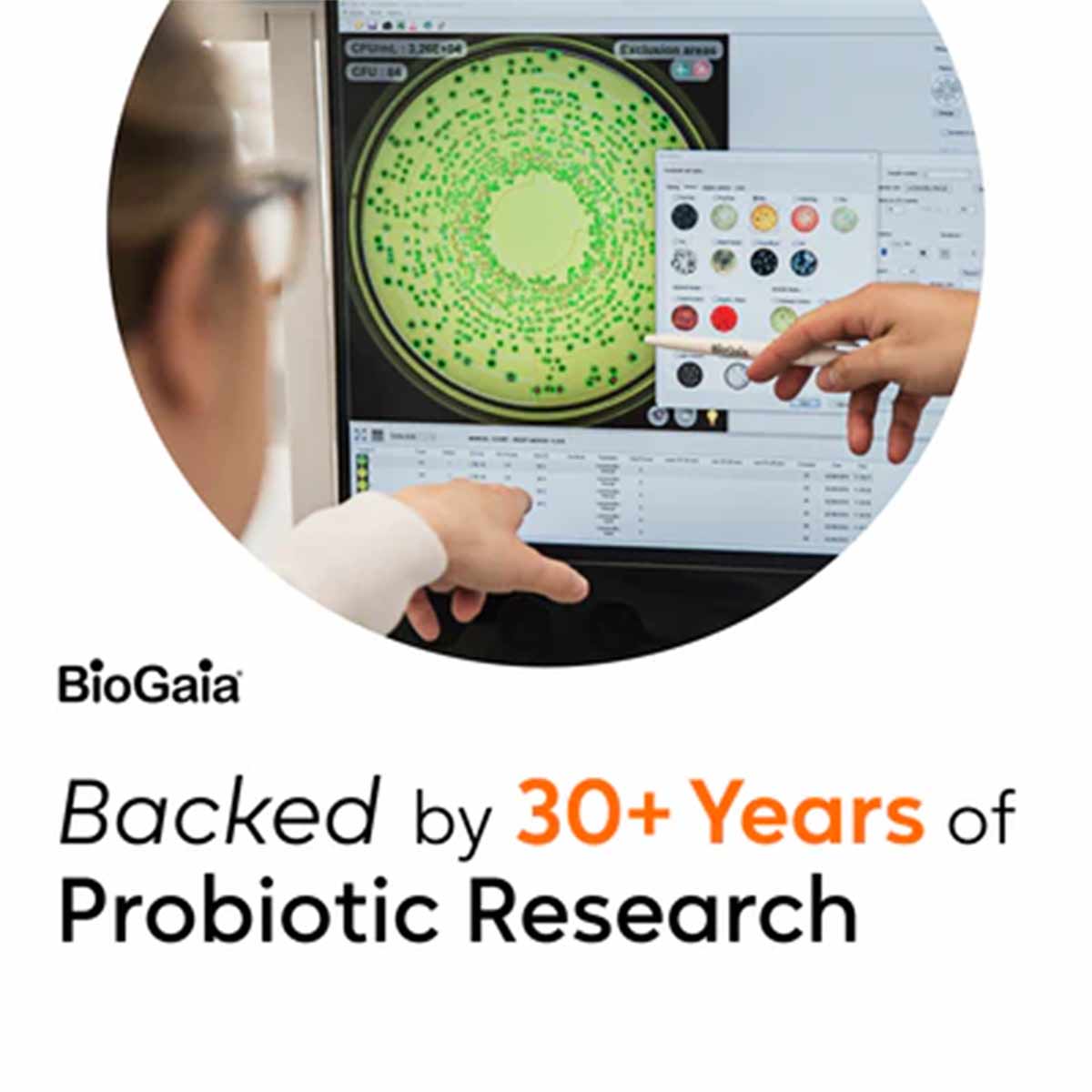 Hands operating laboratory equipment displaying bacterial culture analysis with BioGaia logo and research text.