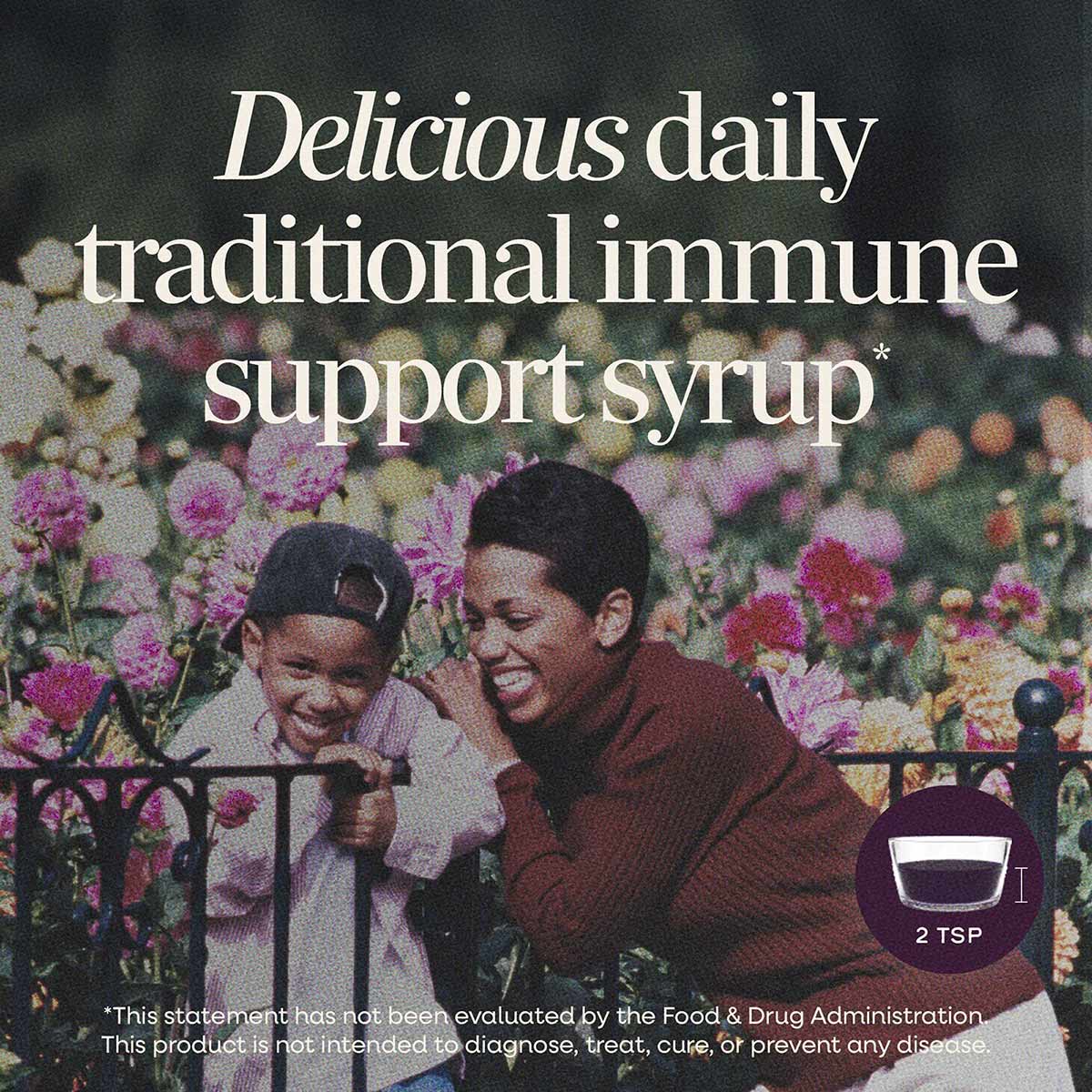 Bottle of dark purple Sambucus elderberry syrup with serving size indicator showing 2 tablespoons.