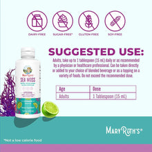 White bottle of MaryRuth's sea moss with spirulina and chlorella liquid supplement next to fresh lime and purple sea moss.