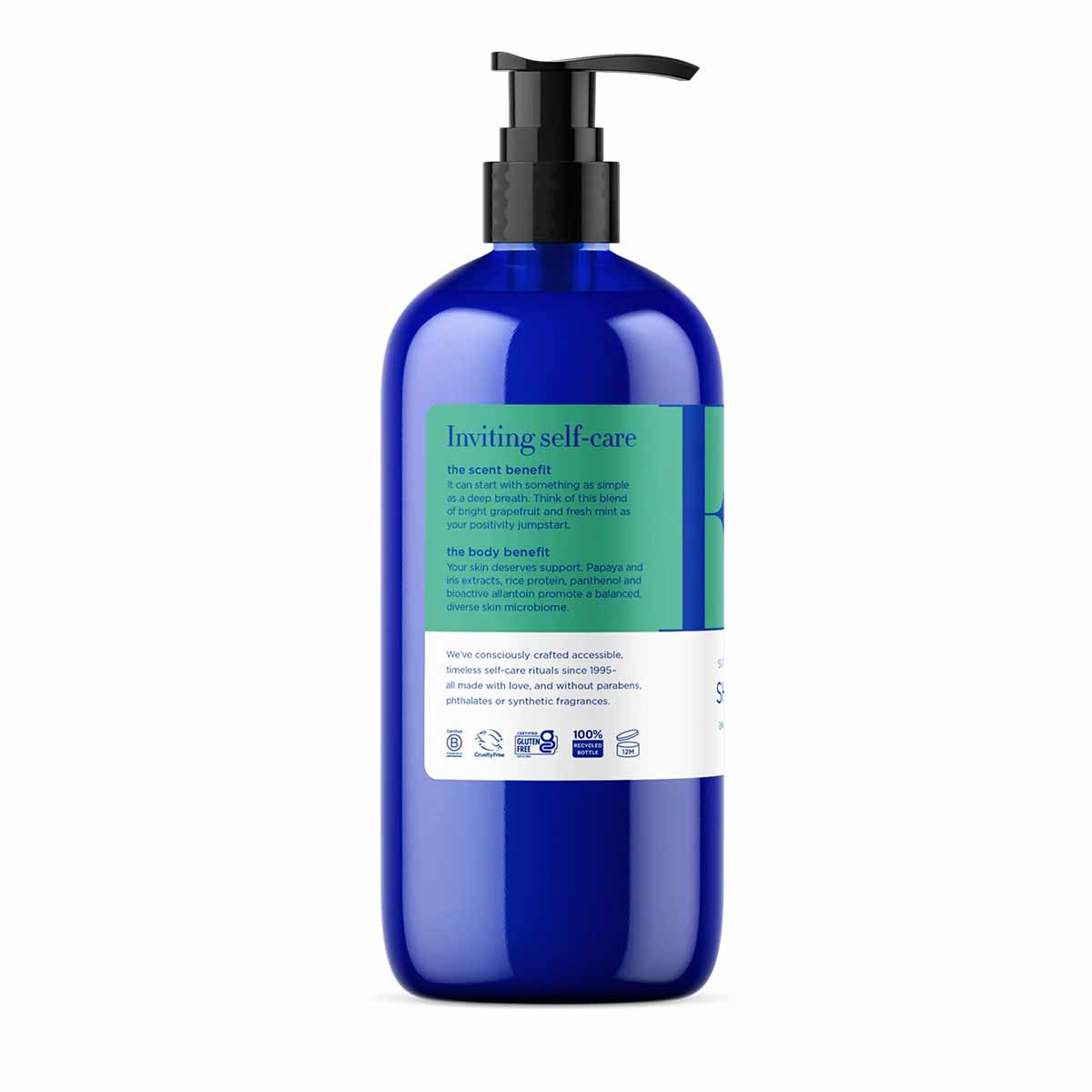 Cobalt blue pump bottle of shower gel with green and white label containing product information and ingredient details.