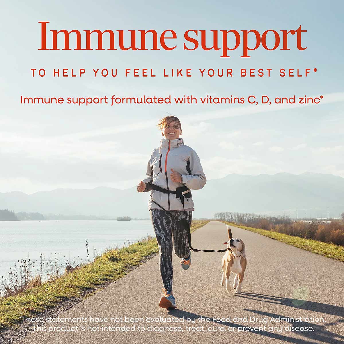 Woman jogging along a waterside path with a dog, with text describing immune support supplement with vitamins C, D, and zinc.