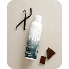 White bottle of Rho Nutrition Tongkat Ali supplement with dark label, displayed next to vanilla pods and dark chocolate piece