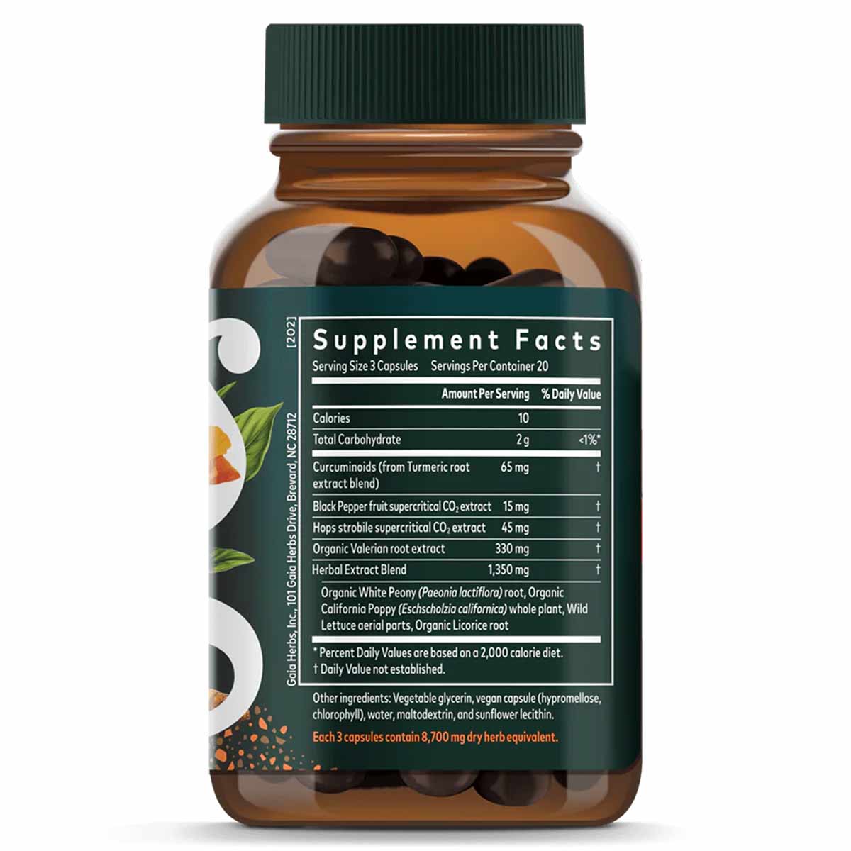 Amber glass bottle with dark green cap containing black capsules and Supplement Facts label detailing turmeric and herbal ing