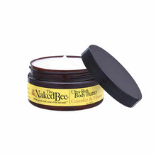 Naked Bee Ultra-Rich Body Butter in Coconut & Honey, dark glass jar with black lid partially removed showing white cream insi
