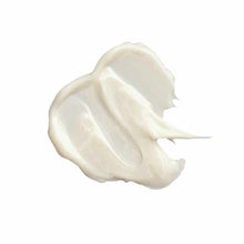 Creamy white body butter with thick, whipped texture and swirled peaks.