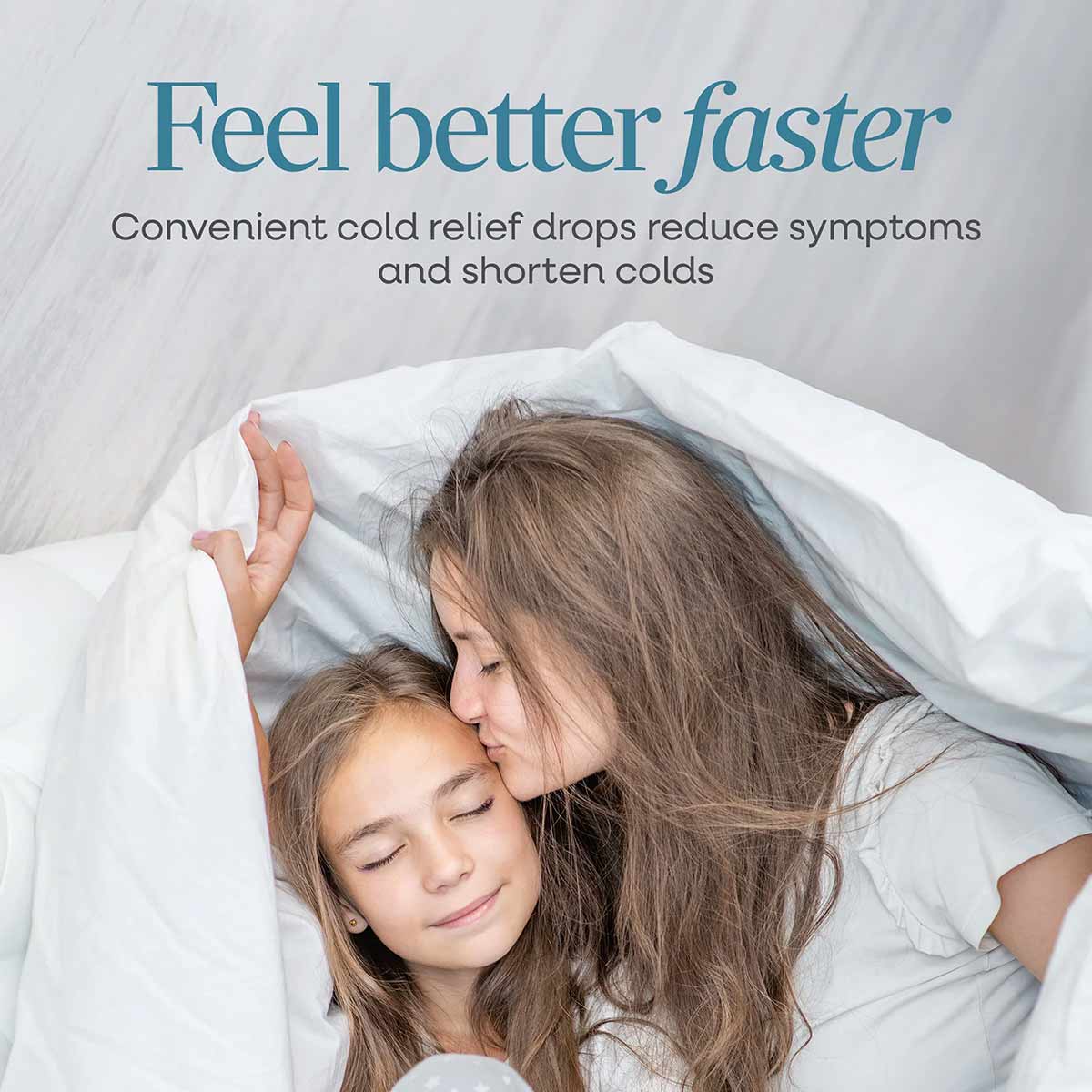 Adult and child resting under white blanket with "Feel better faster" text and cold relief product messaging above.