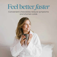 Woman in white shirt holding dark mug with text about Umcka ColdCare chewable cold remedy.