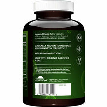 Black vegan supplement bottle with white screw cap and green label displaying usage instructions and ingredient information.