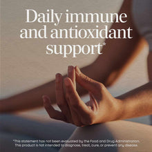 Person's hand holding red vitamin C gummies with text overlay about immune and antioxidant support.