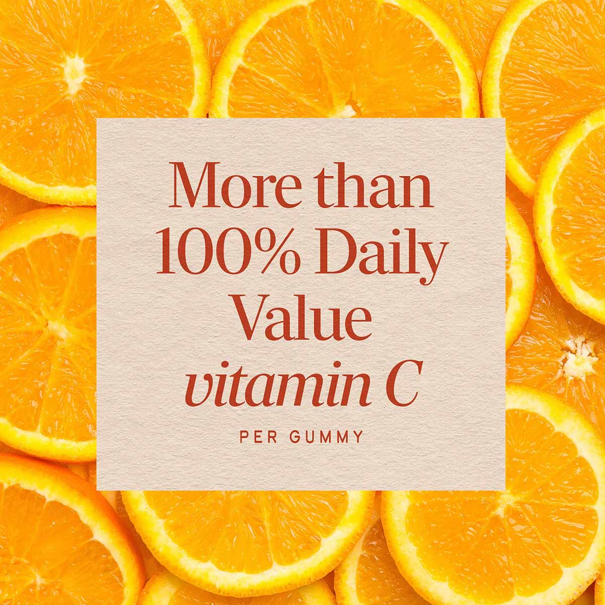 Sliced orange halves surrounding a cream-colored label stating "More than 100% Daily Value vitamin C per gummy" in red text.
