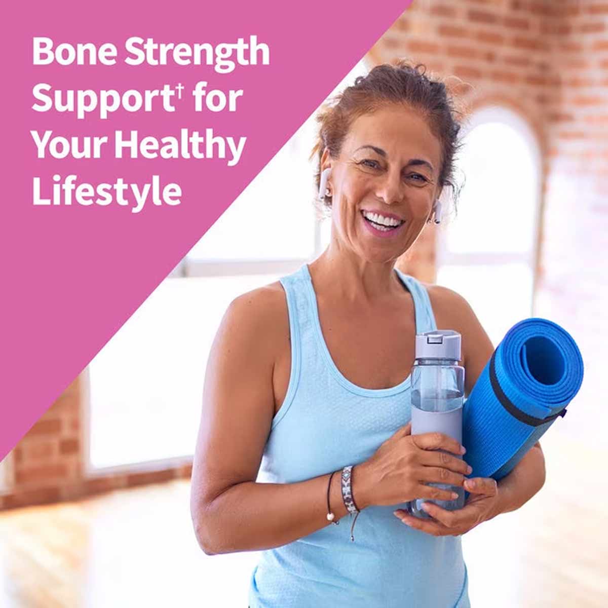 Woman in light blue tank top holding water bottle and blue yoga mat indoors with pink text overlay.