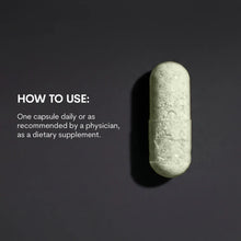 A single translucent capsule filled with pale green powder sits on a dark background beside white usage instructions text.