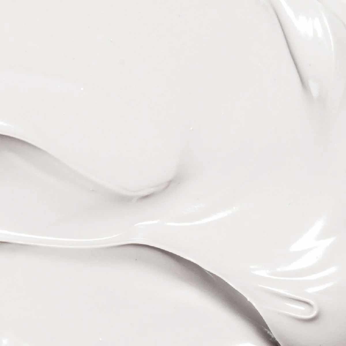 Creamy white body lotion with smooth texture swirls.