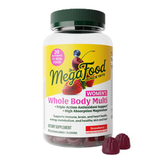 Megafood Women's Whole Body Multi supplement bottle with green cap and strawberry-flavored gummies displayed in front.