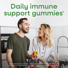 Bottle of Nature's Way Zinc Gummies 11 mg displayed with two people in a kitchen holding fresh produce.
